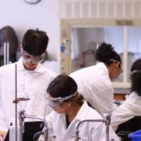 students interacting during a chemistry experiment